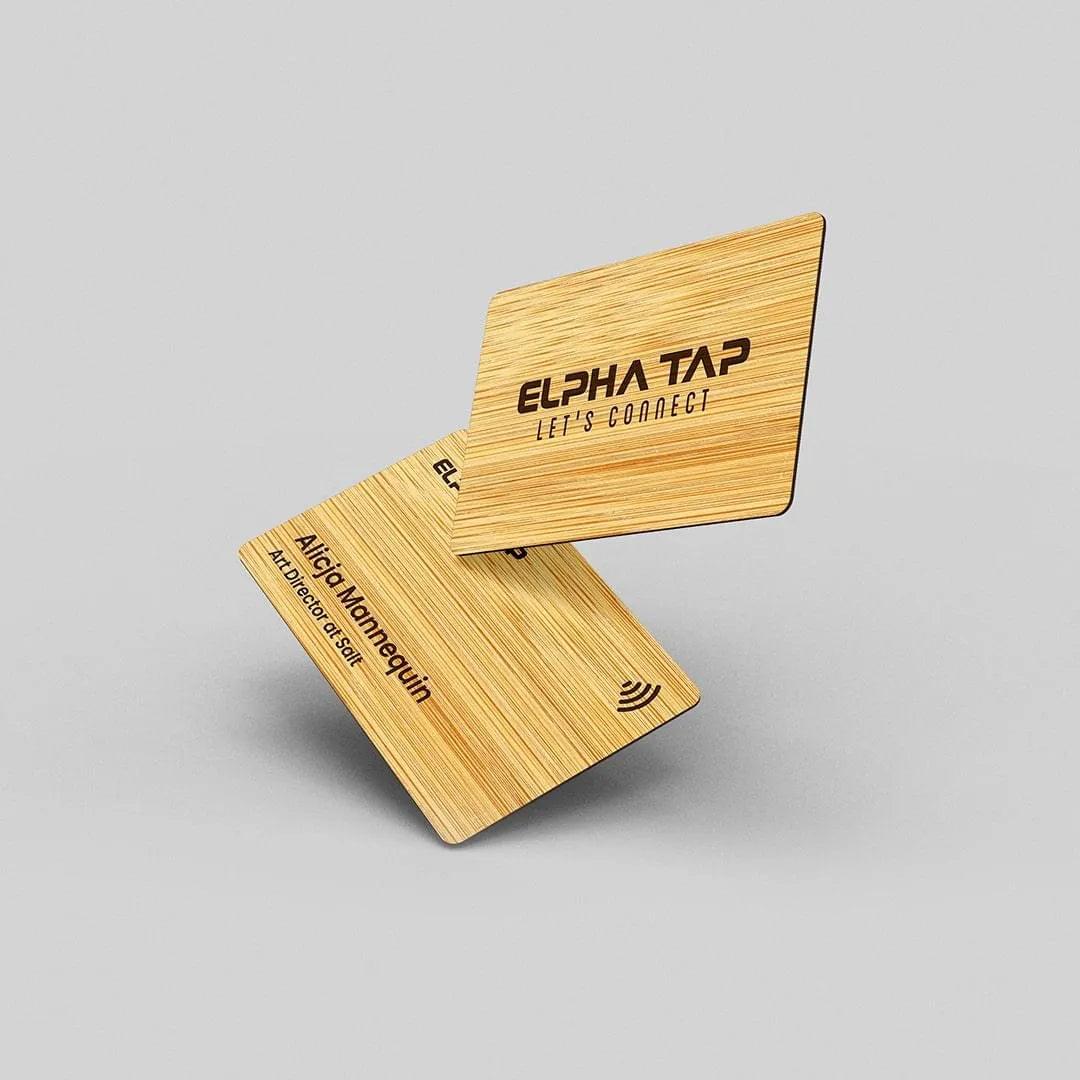 Elegant wooden business cards with engraved text and NFC symbol, modern professional design