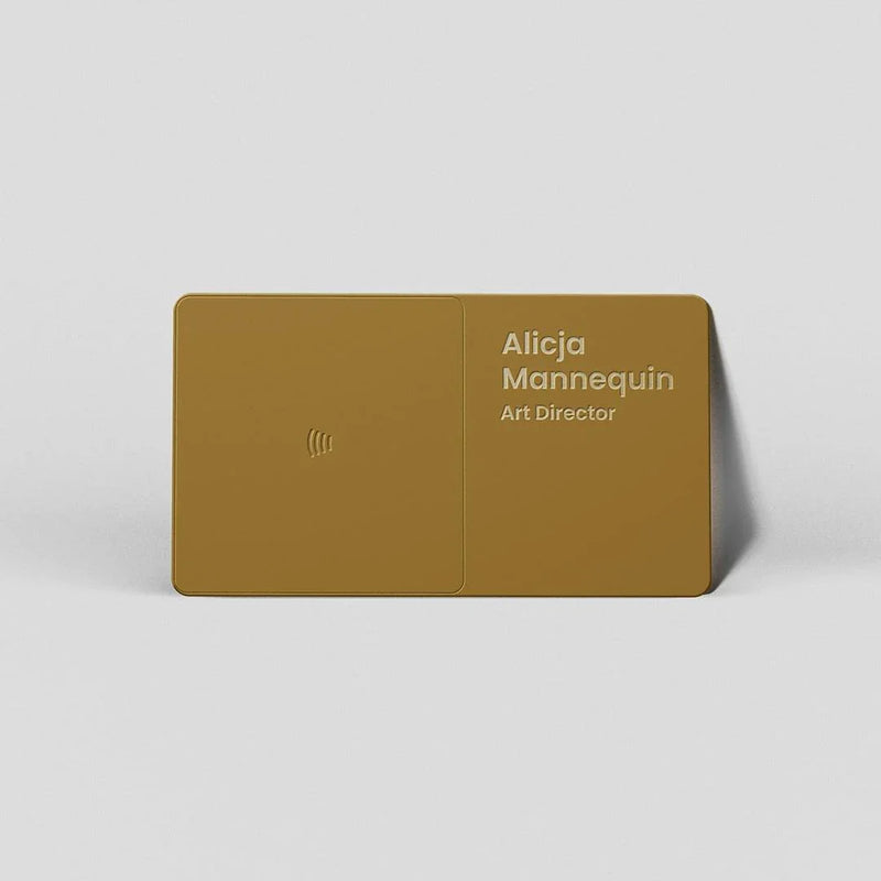 Gold NFC business card for Alicja Mannequin, Art Director, with minimalist design and contactless symbol