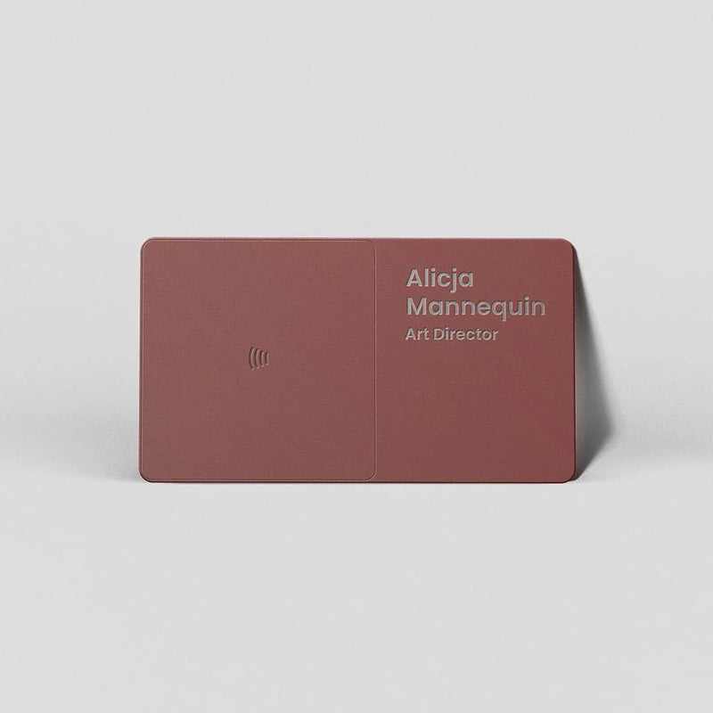 Minimalist maroon business card with embossed name and title, sleek modern design