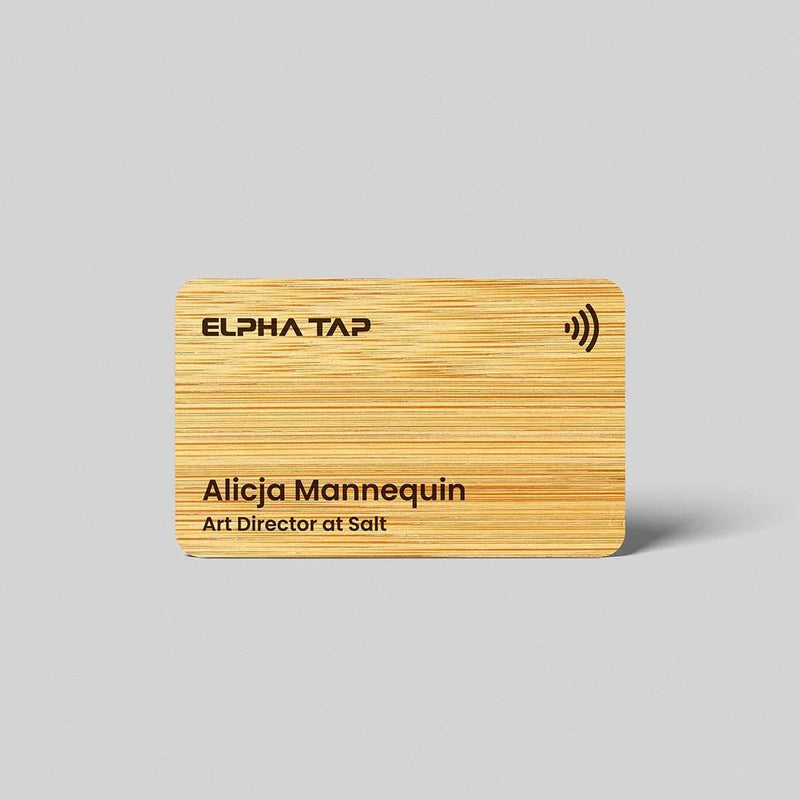 Wooden business card with ELPHA TAP branding and NFC symbol, featuring name and title on natural grain surface